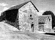 First mill and annex buildings suited at the foot of the castle